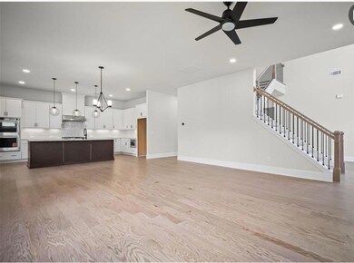 Unfurnished living room featuring light wood-style flooring, recessed lighting, stairway, and ceiling fan