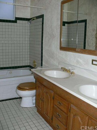 Re-tiled hallway bathroom with dual sinks and show