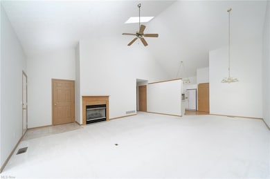 Carpeted living room featuring a lofted ceiling wi