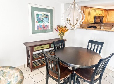 Dining space featuring light tile patterned floors