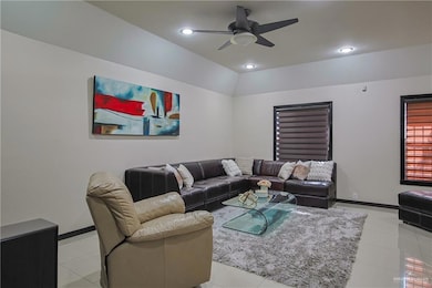 Living room with light tile patterned floors and ceiling fan