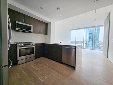 Kitchen with a sink, light countertops, stainless