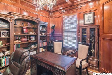 Raised wood paneled walls, wood floor, wood coffered ceiling.  Perfect for a best selling author or perhaps a captain of industry.