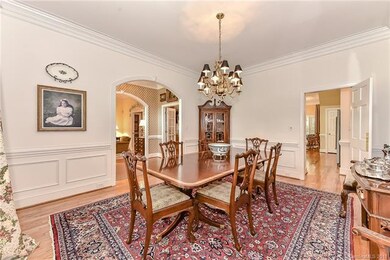 Dining room with beautiful wainscoting and hardwoo
