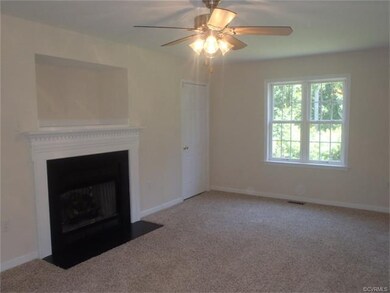 Great Room with gas fireplace and ceiling fan.