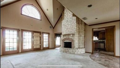 Unfurnished living room with high vaulted ceiling, brick wall, carpet floors, and a fireplace