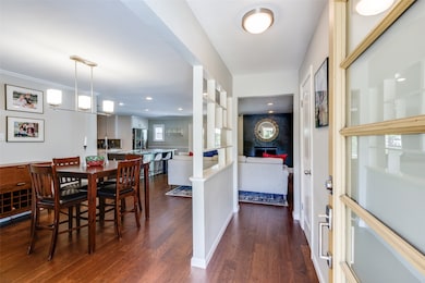 Dining space with dark wood-style floors and recessed lighting