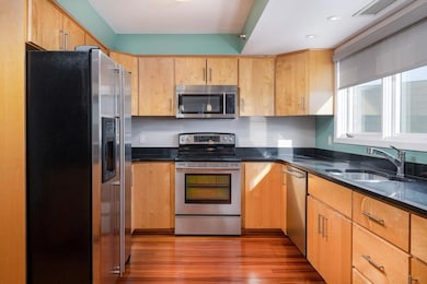 Maple cabinets and stainless-steel appliances.