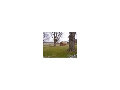 Side fenced lot with shed.