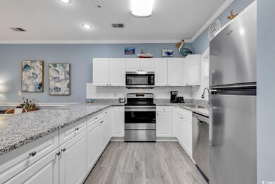 Kitchen with white cabinets, ornamental molding, s