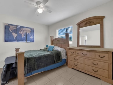 Bedroom featuring ceiling fan and light tile patte