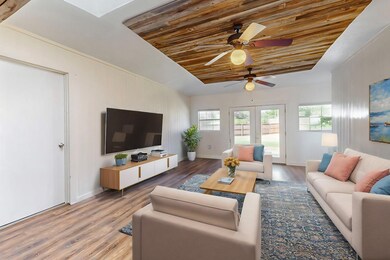Living room with ceiling fan, french doors, wood-t