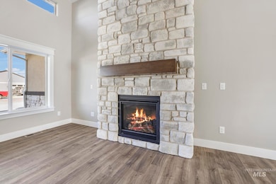 Detailed view of a stone fireplace and wood finished floors