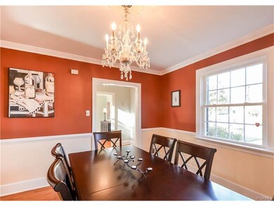 The dining room has hardwood floors, crown molding