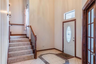 Tiled foyer entrance featuring a high ceiling