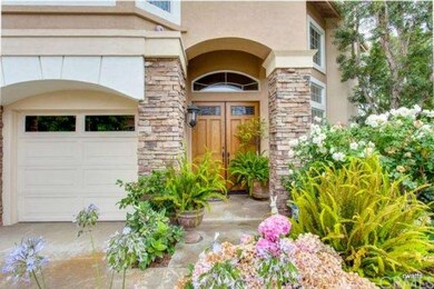 Gorgeous front door with stone work and gardens