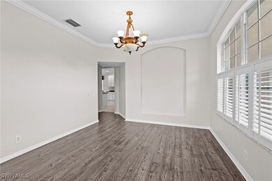 Empty room with baseboards, an inviting chandelier
