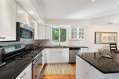 Sparkling white kitchen with beautiful black grani