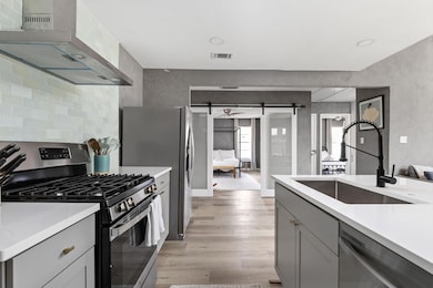 Kitchen featuring appliances with stainless steel