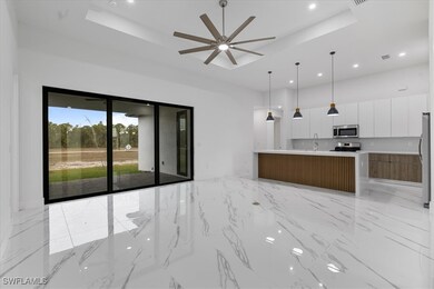 Kitchen featuring a large island with sink, white