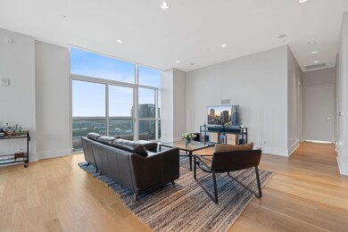 Living room with a wall of windows, visible vents