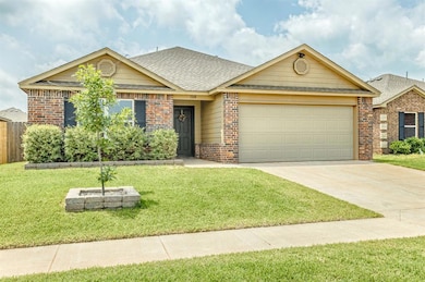 View of front of home featuring brick siding, an attached garage, driveway, and roof with shingles