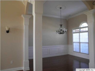 The formal dining room has the hardwood floors, crown molding and picture frame trim plus pillars for separation.