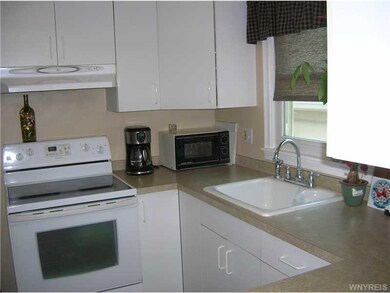 Kitchen. Kitchen features bright, white cabinets a