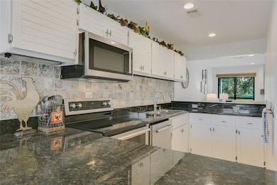 Kitchen with stainless steel appliances, a sink, 