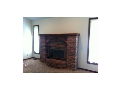 Brick fireplace is focal point of family room, adj