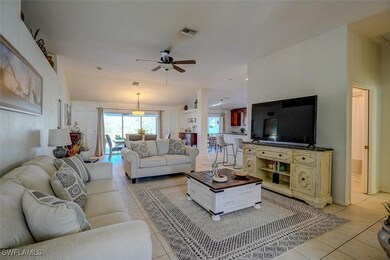 Tiled living room featuring ceiling fan