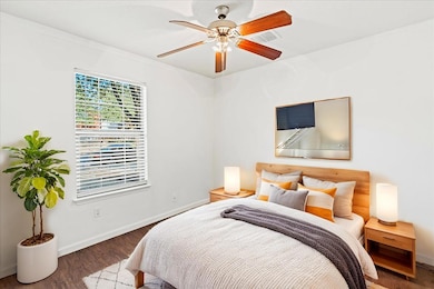 Bedroom with wood finished floors and ceiling fan