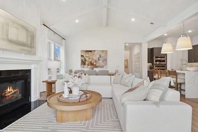 Great room with vaulted ceiling and white painted ceiling beams