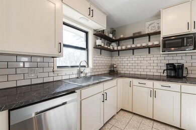 Kitchen featuring light tile patterned floors, app