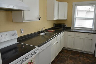 The kitchen includes the range, frig and microwave