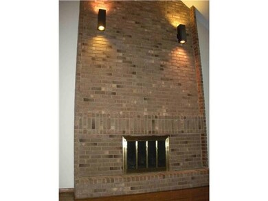 Floor to Ceiling Fireplace with Raised Hearth.