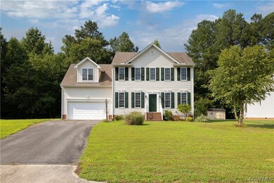 Colonial inspired home featuring garage and a fron