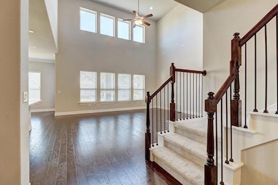 Stairs featuring hardwood / wood-style floors, a 