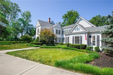 This Beauty sits on about 4 acres of manicured lawn with mature trees and a circle driveway