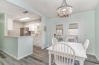 Dining area with visible vents, light wood-style f