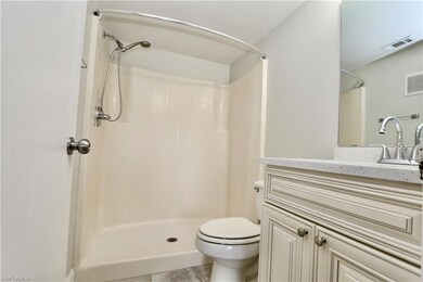 Full bathroom with a shower, toilet, and vanity