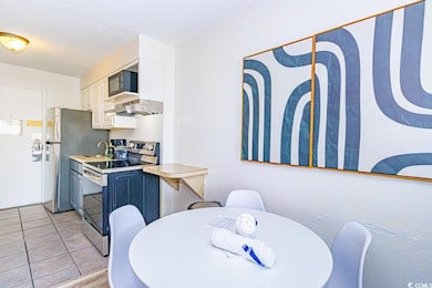 Kitchen featuring sink, white cabinetry, a texture