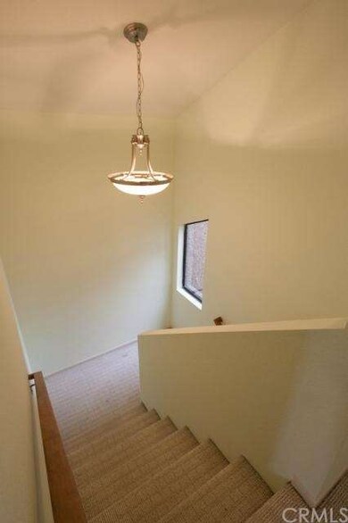 High ceiling stairs leading to second floor.