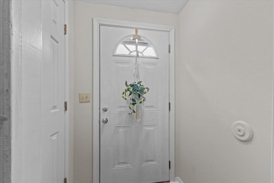 Interior perspective of the front entry with closet to the left.
