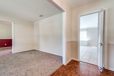 Entry has original parquet flooring. To the left are formal living and dining, straight ahead to generous family room.