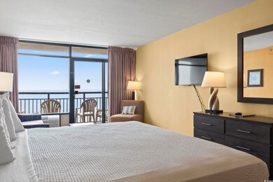 Bedroom with a water view, multiple windows, and f