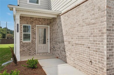 Property entrance with brick siding and fence