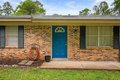 Doorway to property featuring brick siding