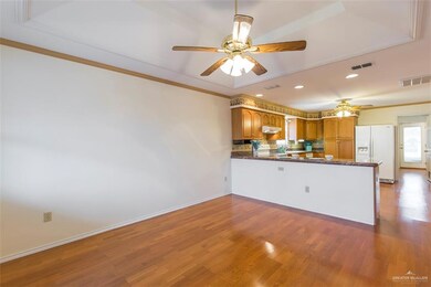 Entry view of living, kitchen and rear bedroom.  Floor plan on this home is ideal and low maintenance inside and out. Lots of cabinets and granite counter tops bring out the elegance in this lovely home.