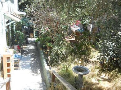 THE SIDE OF THE PROPERTY GOING DOWN TO THE 2ND UNI